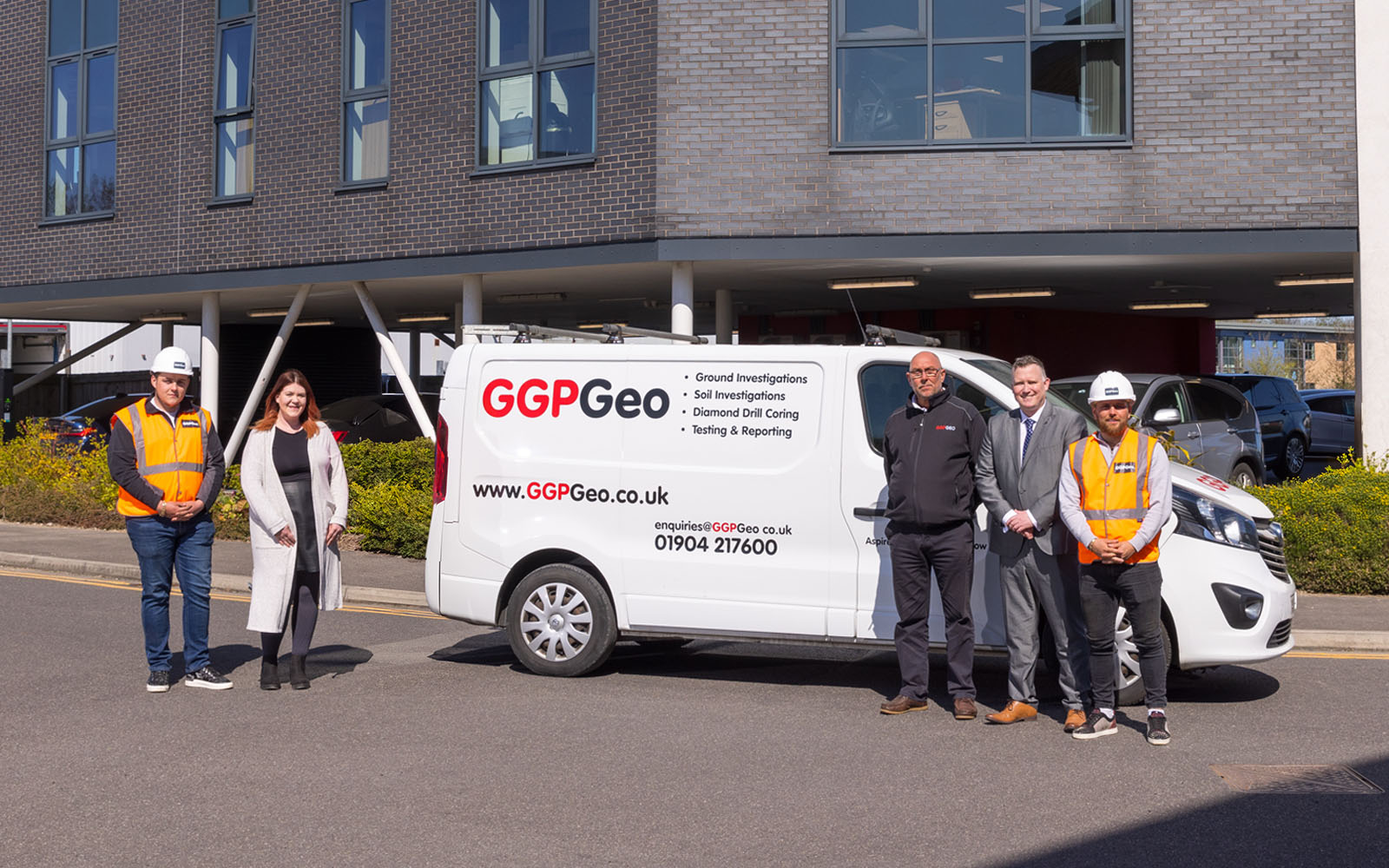 Five workers stood in front of a GGPGeo van.